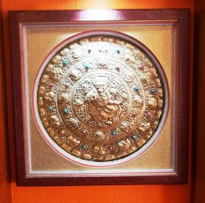 Wall hanging made from hard dye board and Nepali Lokta paper with round buddha metal framing.